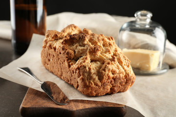 Tasty loaf of beer bread on wooden board