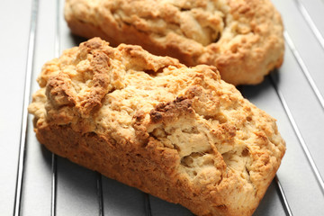 Tasty loafs of beer bread on metal grid