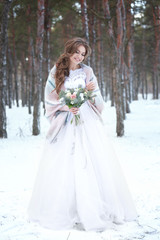 Obraz na płótnie Canvas Beautiful bride with bouquet outdoors on winter day