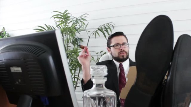 Corporate manager looks at accounts through manilla folder and smokes 