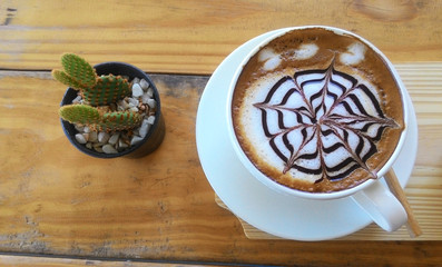 cup of cappuccino on the wooden table background