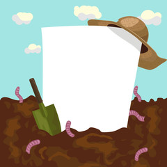 empty blank board with straw hat and garden trowel on ground with earthworms