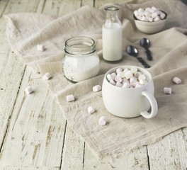 white cup with cocoa and marshmallows, selective focus