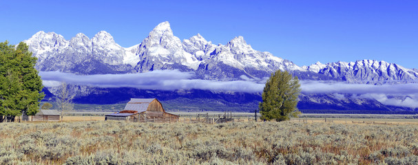 Vintage Barn and Grand Teton and the Teton Range, a popular peak to climb for mountain climbers in Grand Teton National Park, Wyoming, USA