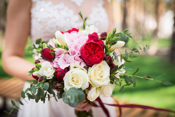 Wedding bouquet with white and red roses, eucalyptus and hydrangea
