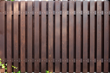 new modern wooden fence dark brown color