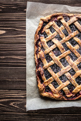 Homemade berry pie on a wooden background