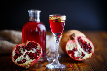sweet pomegranate alcoholic cordial in the decanter with a glass