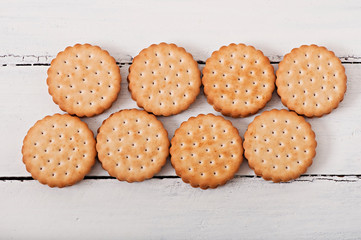 Tasty baked cookies on old wooden background.