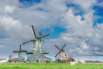 traditional Dutch scenery with windmill of Zaanse Schans with dramatic cloud sky, Netherlands