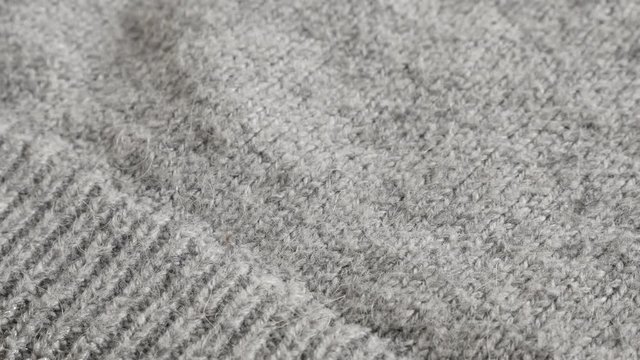 Shallow DOF modern hairy women sweater knitting texture 4K 2160p 30fps UltraHD footage - Shallow DOF fashion gray knitwork 3840X2160 UHD tilting video 