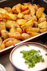 Baked potatoes with herbs and white dip