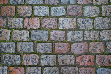 The pavement of colored stones. Traditional paving in Bruges, Belgium.