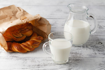 Cup of milk and pastry on table