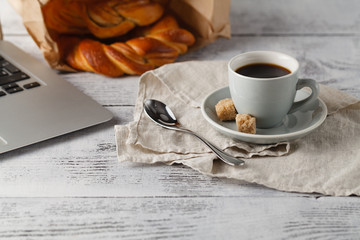 cup of brew coffee on table in office with laptop