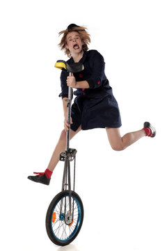 clown entertainer poses with a unicycle