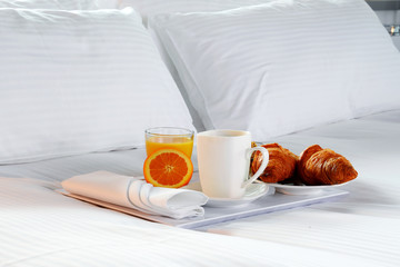 Breakfast in bed in hotel room.