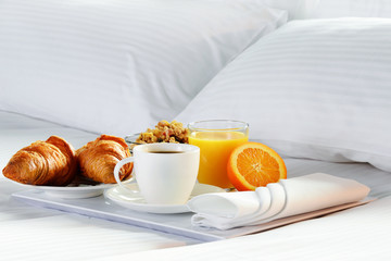Breakfast in bed in hotel room.