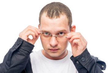 a man with poor eyesight correcting glasses isolated