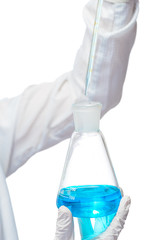 glass flask and pipette in the hands of an experienced chemist c