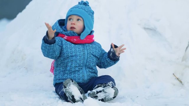 child sitting in the snow