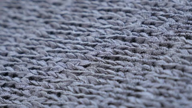 Modern texture of gray clothing knitwork close-up slow tilt 4K 2160p 30fps UltraHD footage - Shallow DOF knitting made sweater details 3840X2160 UHD tilting video 