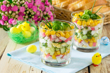 Salad with crab sticks, eggs, corn and cucumber. Festive snack o