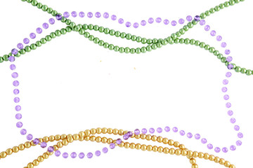 Mardi Gras beads background with place for text. Top view