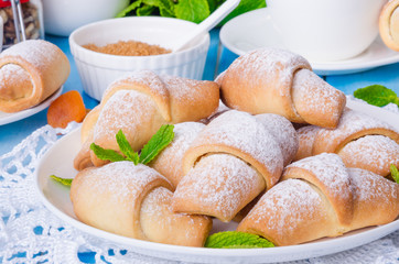 Mini croissants with dried apricots, figs and nuts on a plate