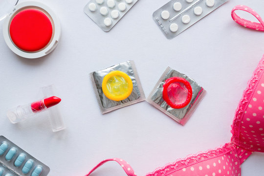 Women's Accessories, condoms and birth control pills on a white background