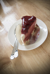 Piece of strawberry cheesecake on white plate,food and snack bac