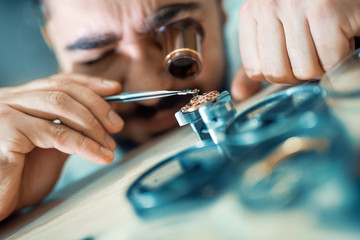 Close up portrait of a watchmaker at work
