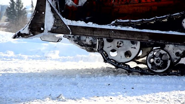 cleaning snow tracked vehicles. snow removal crawler tractor.
