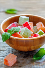 Wooden bowl with traditional oriental dessert Turkish Delight.