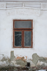 The window in one of the oldest houses, old wall