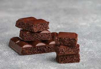 Porous milk chocolate, broken into pieces. Selective focus