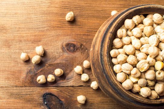 Portion of Chick Peas in wooden bowl, top view