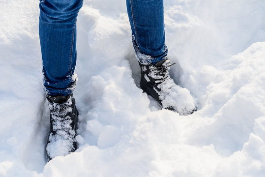 Blue Denim Jeans And Winter Boots In Fresh Snow
