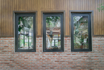 Brick walls are decorated with black three frames .