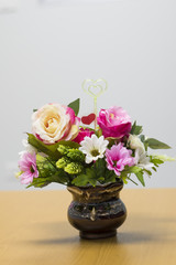 Fake flowers on  brown  vase