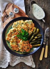 Chops chicken fillet with onion and parsley fried in olive oil.