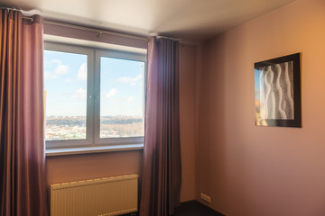 Fototapeta premium Interior of a new bedroom with a window and a picture on the wall