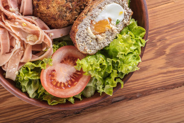 spaghetti and scotch egg with vegetables