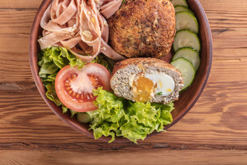 spaghetti and scotch egg with vegetables