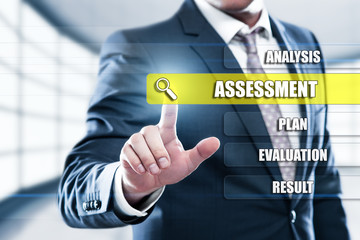 Assessment Analysis Evaluation Measure concept on presentation screen. Man pressing button on display with word in modern office