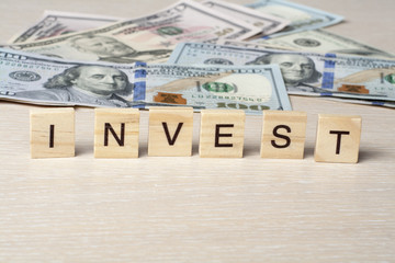 INVEST Word on Cube. Finance Concept. Money