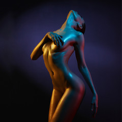Elegant nude model in the light colored spotlights