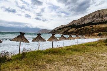 Fototapeta na wymiar lonely beach with umbrellas