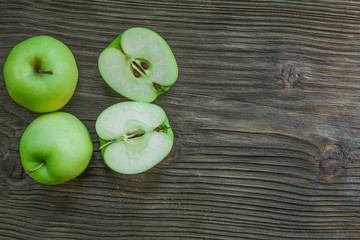 Ripe green apples on wooden background