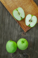 Ripe green apples on wooden background